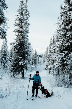 Cross-Country Skiing with Alaskan Malamute in Snowy Forest