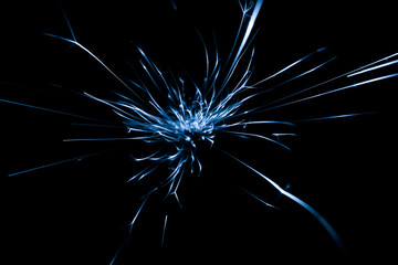 blue sparks from the grinder glowing in the dark