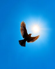Obraz premium A silhouette of a bird in flight against a bright blue sky, symbolizing freedom and nature's beauty.