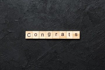Congrats word written on wood block. Congrats text on cement table for your desing, Top view concept