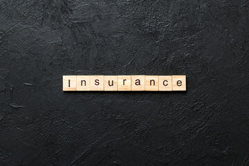 insurance word written on wood block. insurance text on table, concept