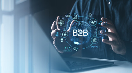 Digital representation of B2B concept with data icons, holographic graphics, and a laptop in a...