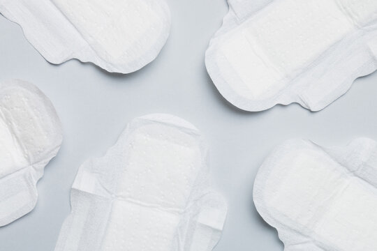 Women hygiene products or sanitary pad on colored background. Pastel color. Closeup. Empty place for text. Female daily hygiene