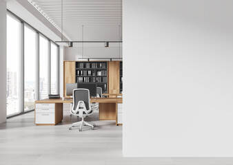 Modern office interior with wooden desks, white chairs, shelves, and large windows in an open...