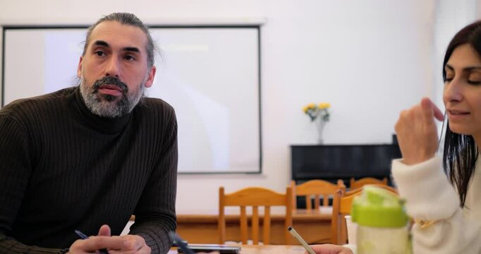 Man and woman in training environment illustrates teamwork potential guiding shared tasks, building teamwork momentum through open dialogue, and reinforcing teamwork bonds across diverse participants