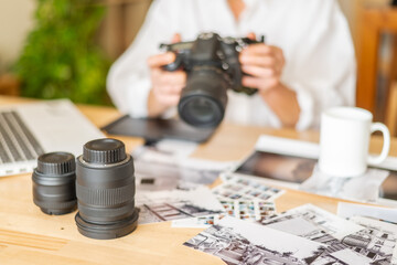 Professional photographer working with camera equipment, capturing images on sunlit workspace