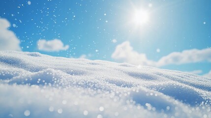 Fresh snow falling on a snow-covered landscape under a bright blue sky.