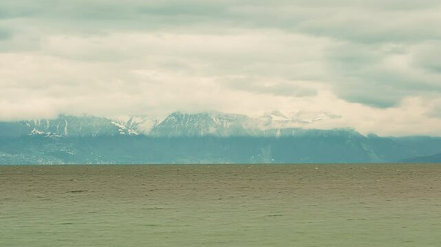 Timelapse of Lake Geneva and snowy mountains in Morges Canton of Vaud Switzerland