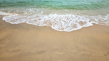 Sea water wave and sand beach with seashell background for decoration on summer holiday and coastal concept.