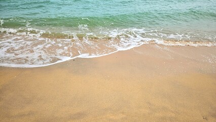 Sea water wave and sand beach with seashell background for decoration on summer holiday and coastal concept.