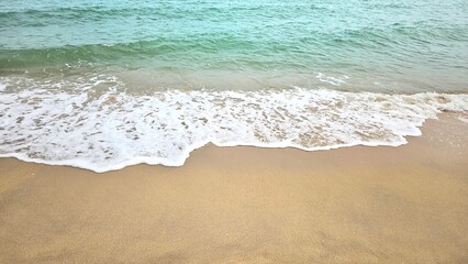 Sea water wave and sand beach with seashell background for decoration on summer holiday and coastal concept.