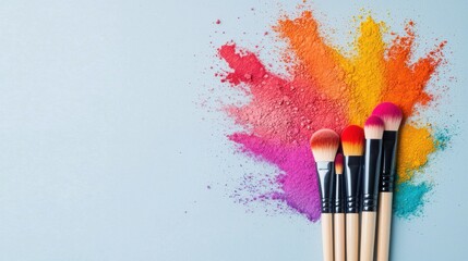 Vibrant makeup brushes arranged in a fan shape with a colorful powder explosion backdrop showcasing the creative tools and supplies used by professional makeup in the cosmetic industry