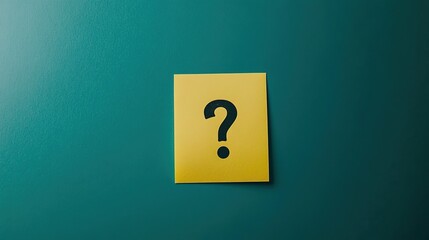 A yellow sticky note with a black question mark on a teal background
