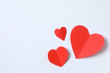 Beautiful red paper hearts on white background