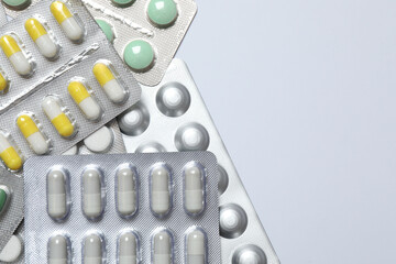 Various pills in blisters on white background