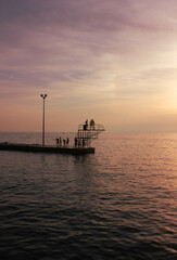 Obraz premium Bathers on the Adriatic Sea are taking advantage of the last rays of the sun to enjoy