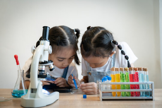 Girl Conducting Science Experiment with Red Liquid in Lab