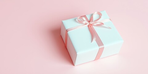 Fototapeta premium A delicately wrapped present, a gift box tied with a soft pink ribbon, sits on a pale pink background.