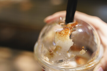 Close-up of bubble tea cup with sugar syrup.