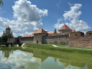 Fototapeta premium Majestic Medieval Fortress Surrounded by a Defensive Moat