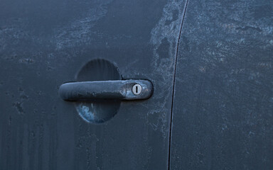 Frozen car lock, hard frost. Gray background. Winter time.