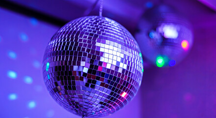 A shimmering disco ball reflects vibrant blue hues in a mesmerizing dance of light and color. Perfect for setting the mood in any party scene. Experience the magic. Generated AI