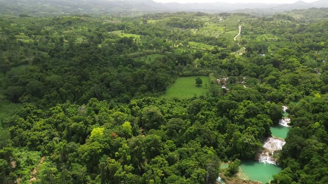Aerial drone overview of Cascadas Roberto Barrios with turquoise water and lush greenery, panoramic tracking right