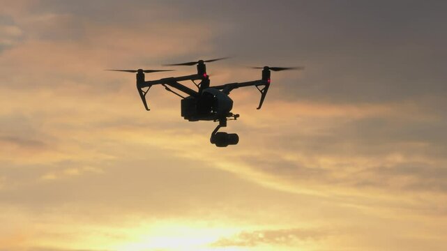 Drone flying at sunset in slow motion with clouds and a colorful sky