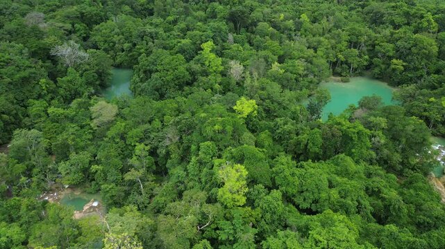 Lush aerial overview of Cascadas Roberto Barrios showing cascading waterfalls in the jungle, static