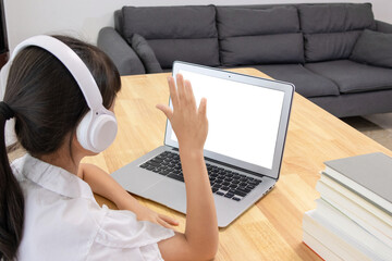 Chinese little girl attending online classes at home