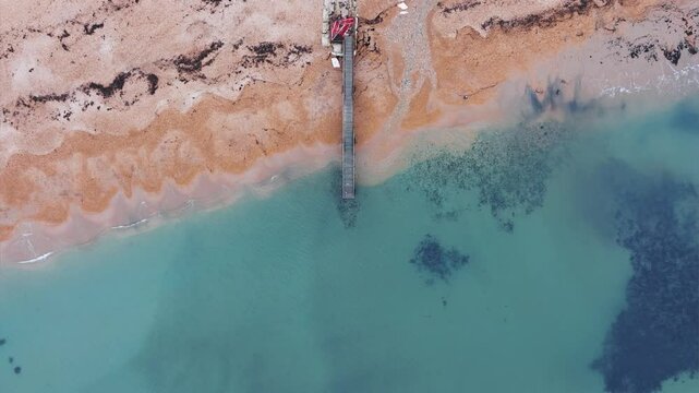 Aerial Drone View of Wooden Jetty in Calm Blue Winter Sea