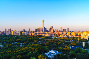 Skyline of Beijing CBD at sunrise with golden sunlight on skyscrapers