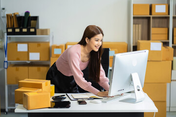 Concept of selling products online.entrepreneur or freelance checking orders from customers, woman runs an e-commerce business on websites and social media.