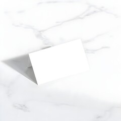 Blank business card Mockup on smooth marble slab at an angle. Elegant and minimal design with light tones.
