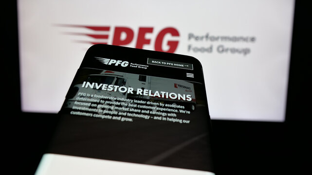 Stuttgart, Germany - 12-11-2024: Mobile phone with website of US company Performance Food Group Company (PFG) on screen in front of logo. Focus on top-left of phone display.