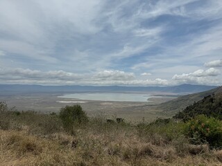 Naklejka premium landscape with impressive dramatic clouds in the landscape of the ngorongoro crater tanzania safari, savannah steppe grass safari wildlife