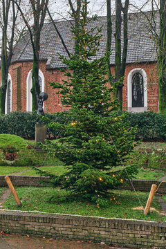 Christmas Tree with Lights in Front of Historic Church