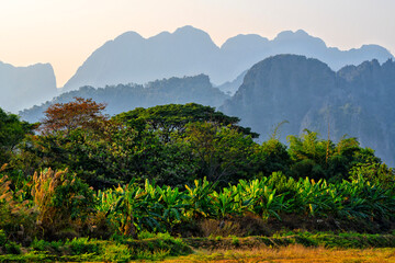 Obraz premium Panorama of karst mountains with mist at sunrise, Vang Vieng, Vientiane Province, Laos, Asia