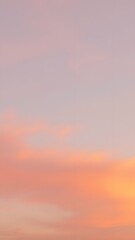 Fototapeta premium Pastel Sunset with Soft Clouds - Vertical Phone Wallpaper Background