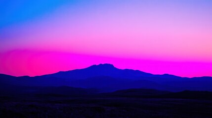 Silhouettes of Mountains at Sunset with Vibrant Pink and Blue Sky