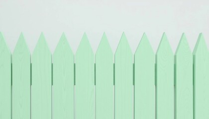 Symmetrical mint-colored picket fence with a clean, neutral backdrop