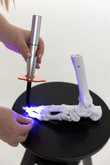 Educating a physician using a leg replica.