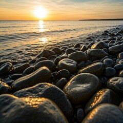 A peaceful coastline bathed in warm sunlight, dew drops glistening on smooth rocks near the shore.
