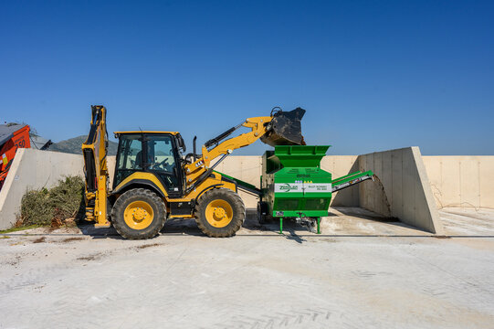 Industrial Composting Facility with Heavy Machinery and Compost Piles