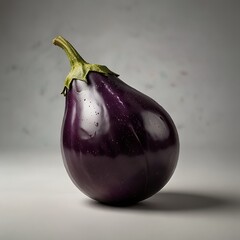 A solitary purple eggplant displayed against a dark backdrop