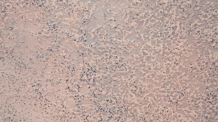 Textured abstract surface with a speckled pink and blue pattern