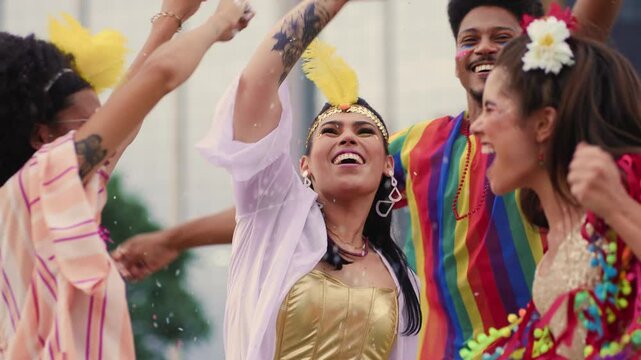 Smiling Friends Throwing Confetti at a Brazilian Carnival Celebration. Joyful Group Dressed in Colorful Costumes Enjoying Vibrant Carnaval Festivities Outdoors