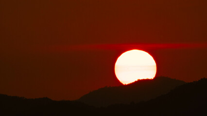 Timelapse shot of a beautiful sunrise over the horizon with an orange winter sky. Close-up of the sunrise. Morning dawn landscape.