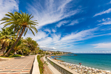 Scenic view of the Sanremo waterfront promenade with palm trees and Mediterranean Sea