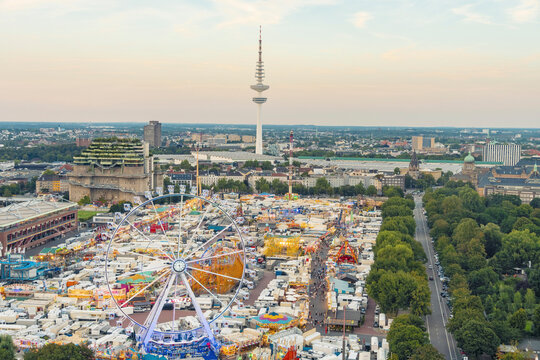 Aerial view of Heiligengeistfeld with a Christmas market and amusement park in St Pauli, Hamburg, Germany, featuring the TV tower and bunker in the background.